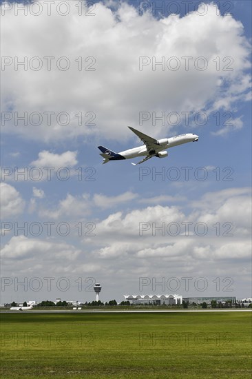 Lufthansa Airbus A350-900 taking off on runway south with tower, Munich Airport, Upper Bavaria, Bavaria, Germany, Europe