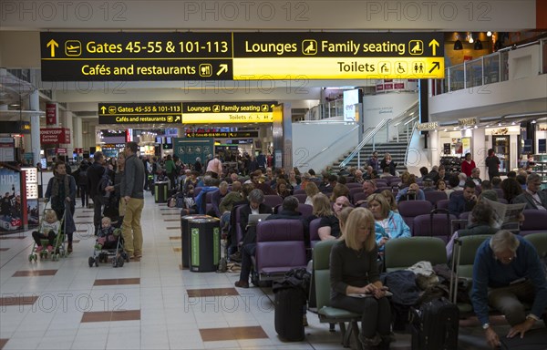 People waiting in departure lounge, Gatwick airport north terminal, London, England, UK