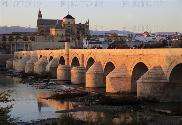 Roman bridge spanning river Rio Guadalquivir with Mezquita buildings, Cordoba, Spain, Europe