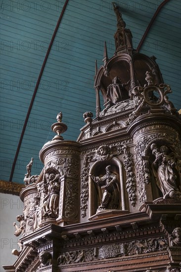 Renaissance-style carved canopy of the baptismal font, Enclos Paroissial enclosed parish of Guimiliau, Finistere Penn ar Bed department, Brittany Breizh region, France, Europe