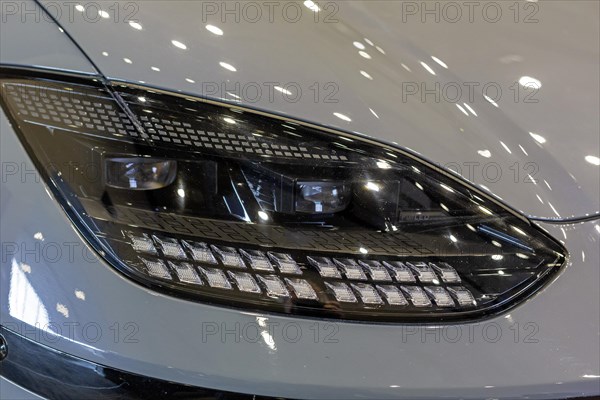 Pontiac, Michigan USA, 4 January 2024, A headlight of the Hyundai Ioniq 6 electric car, which was runner-up in the North American Car of the Year award. The annual North American Car, Truck and Utility Vehicle of the Year (NACTOY) awards are judged by a panel of professional automotive journalists
