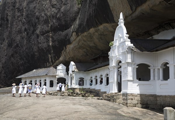 People at Dambulla cave Buddhist temple complex, Sri Lanka, Asia