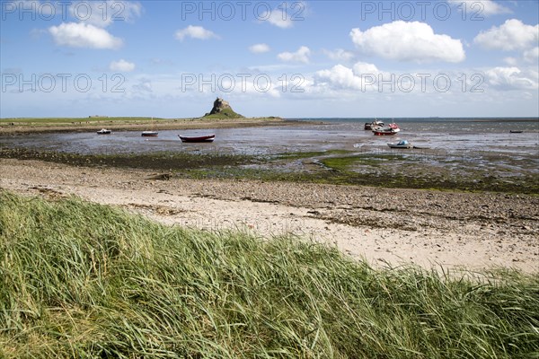 Castle and boats at low tide, Holy Island, Lindisfarne, Northumberland, England, UK