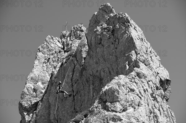 Climber abseiling on the Rosssteinnadel, mountaineering village Kreuth, Mangfall mountains, Bavarian Prealps, Upper Bavaria, Bavaria, Germany, Europe