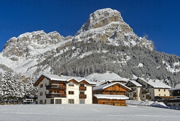 The snow-covered hamlet of Colfosco, Colfosco, at the foot of the Sassongher peak, Colfosco, Corvara, Alta Badia ski area, Dolomites, South Tyrol, Italy, Europe