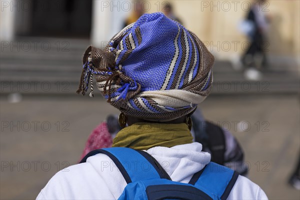 Turban of an African migrant in the Piazza de Ferrarim Genoa, Italy, Europe
