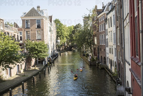 People kayaking on Oudegracht canal in central Utrecht, Netherlands