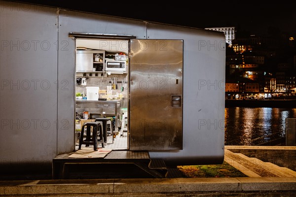 Kitchen in a food stall by the river at night, Porto, Portugal, Europe