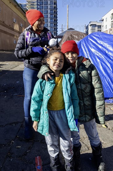 Denver, Colorado, Immigrants, mostly from Venezuela, live in a tent camp near downtown Denver. The city helped about 35, 000 migrants in 2023 with food and temporary shelter, but more continue to arrive daily on buses from the southern border