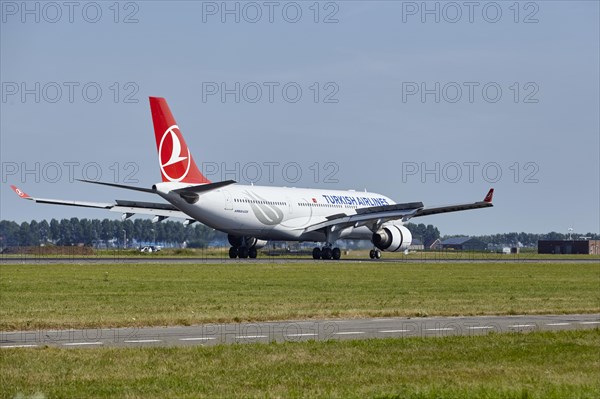 Turkish Airlines Airbus A330-223 with registration TC-LOH lands on the Polderbaan, Amsterdam Schiphol Airport in Vijfhuizen, municipality of Haarlemmermeer, Noord-Holland, Netherlands