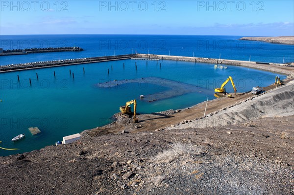 View of two excavators dredging harbour basin new marina harbour for pleasure boats yachts yachts extension of the marina of holiday resort Morro Jable, in the background harbour wall, left behind large harbour pier, in the background Atlantic Ocean, Morro Jable, Jandia peninsula, Fuerteventura, Canary Islands, Canary Islands, Spain, Europe