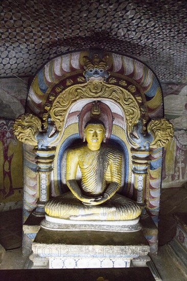 Buddha figure inside Dambulla cave Buddhist temple complex, Sri Lanka, Asia