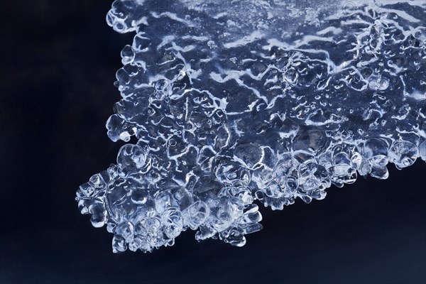 Ice formations formed by frost and freezing cold temperatures over running water of stream