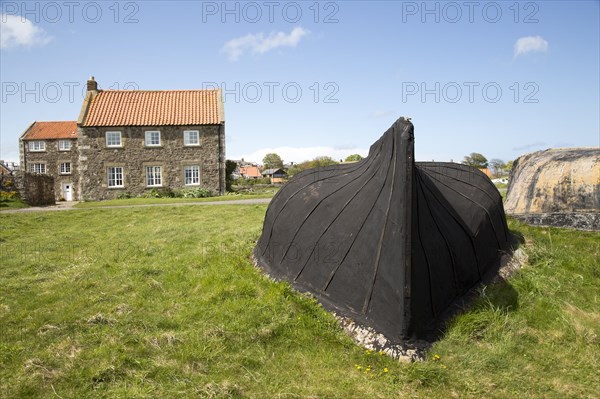 Upturned boats used as storage shed, Holy Island, Lindisfarne, Northumberland, England, UK