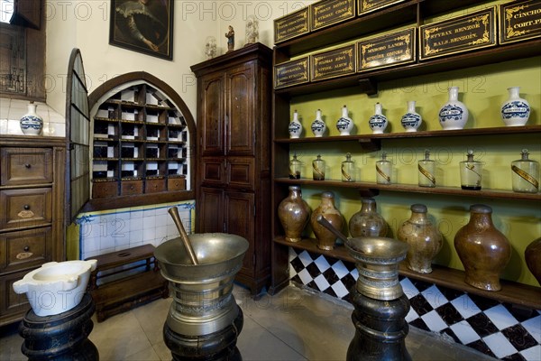 Jars and pitchers on shelves in pharmacy in the old Saint John's Hospital museum in Bruges, Belgium, Europe