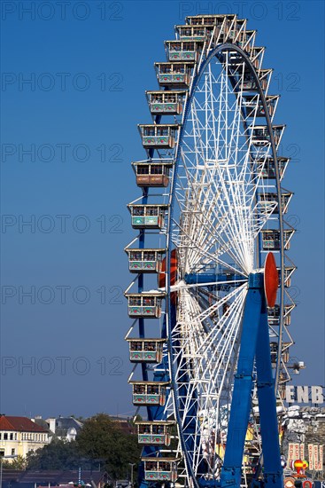 Oktoberfest, afternoon, people, visitors having fun on the Ferris wheel, Munich, Bavaria, Germany, Europe