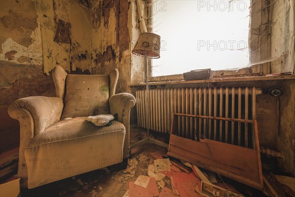 Depicting a dilapidated armchair and severe decay in a neglected room, Urologist's Villa Dr Anna L., Lost Place, Bad Wildungen, Hesse, Germany, Europe