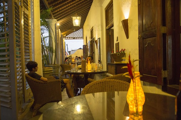 Evening drinks colonial style veranda bar of Galle Fort Hotel, historic town of Galle, Sri Lanka, Asia