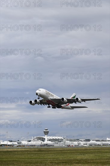 Emirates Airways Airbus A380-800 take-off on southern runway with control tower, Munich Airport, Upper Bavaria, Bavaria, Germany, Europe