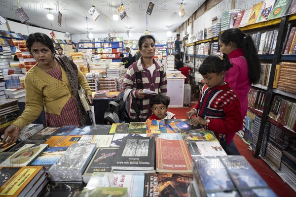 Book readers browsing books at a stall during Assam Book Fair, in Guwahati, Assam, India on 29 December 2023