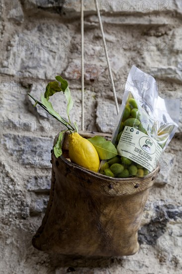 House facade with decoration and advertising, leather bag with lemon and olives, Limone sul Garda, Lake Garda, Province of Brescia, Lombardy, Italy, Europe