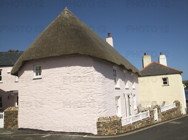Traditional yellow and pink cottages in St Mawes, Cornwall, England, UK
