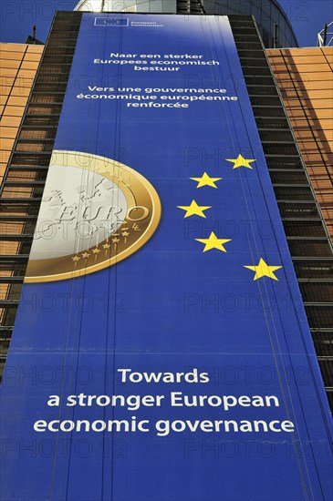 Banner about the euro hanging from the Berlaymont building of the European Commission, executive body of the European Union, Brussels, Belgium, Europe