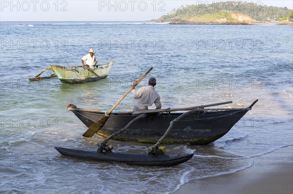 Fishing using traditional outrigger canoes, Mirissa, Sri Lanka, Asia