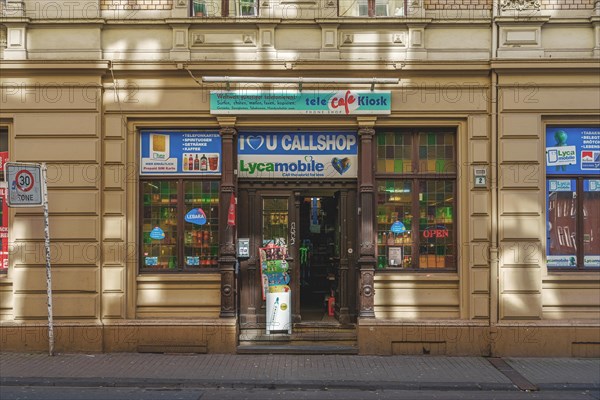 Small business with colourful advertising signs and shop window in a city street, Wuppertal Elberfeld, North Rhine-Westphalia, Germany, Europe