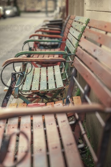 A row of coloured park benches in an empty public park, Wuppertal Elberfeld, North Rhine-Westphalia, Germany, Europe