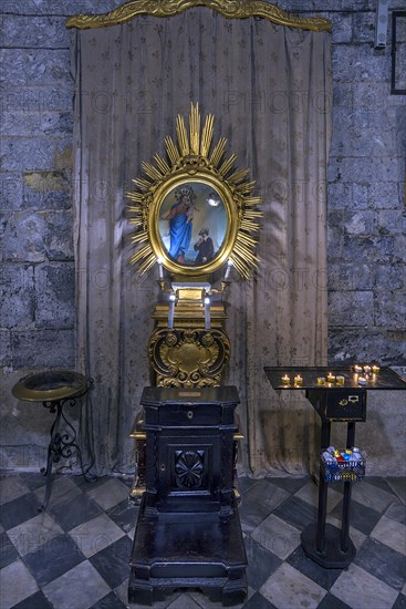 Prayer room with sacrificial candles in the church of San Donato, 12th century, Via S. Donato, 10, in the centre of Genoa, Italy, Europe