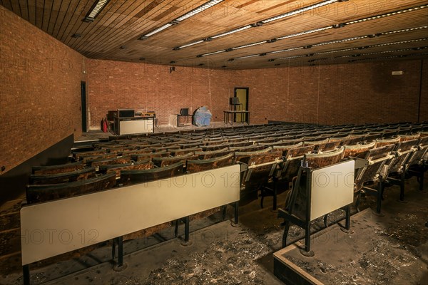 An abandoned lecture theatre with damaged wooden seats and a spherical model on the stage, Biotech, abandoned university, Lost Place, Sint-Genesius-Rode, Belgium, Europe