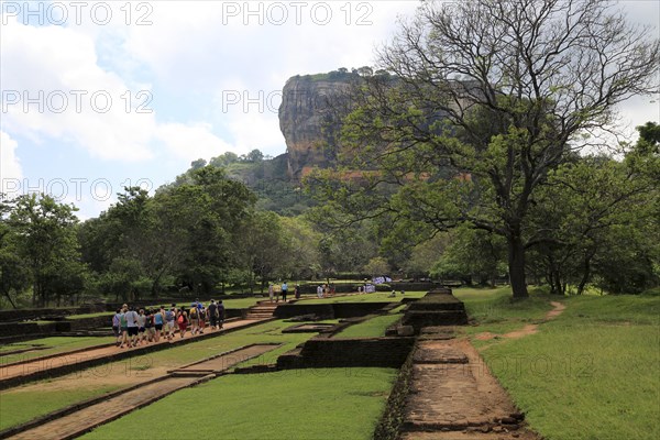 Tourists walking in the palace water gardens, Sigiriya Rock palace, Central Province, Sri Lanka, Asia