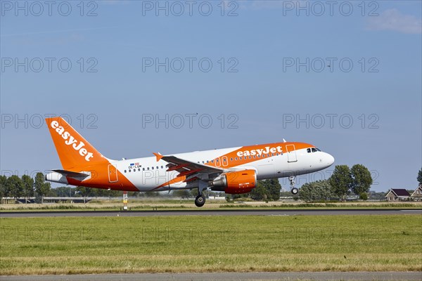 EasyJet Airbus A319-111 with registration OE-LQM lands on the Polderbaan, Amsterdam Schiphol Airport in Vijfhuizen, municipality of Haarlemmermeer, Noord-Holland, Netherlands