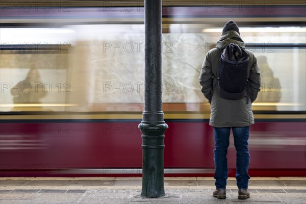 A man stands at Friedrichshagen S-Bahn station while the S-Bahn arrives. Today is the second day of the strike by the train drivers' union GDL, on which train cancellations are to be expected. Berlin, 11.01.2024