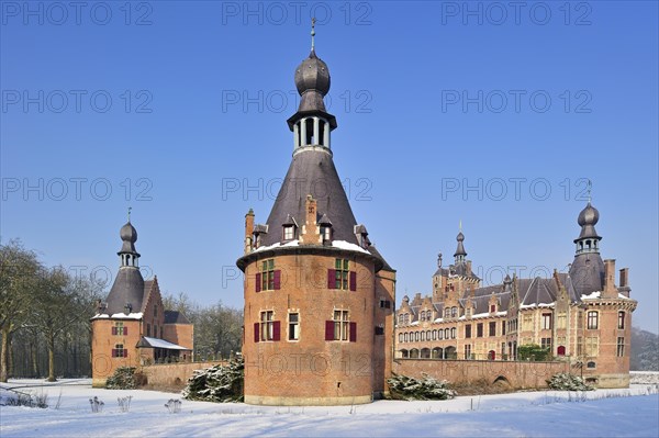The medieval Ooidonk Castle in the snow in winter, Belgium, Europe