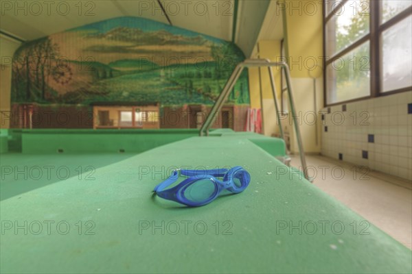 A lost diving diving goggles on a diving board in an empty swimming pool, Bad am Park, Lost Place, Essen, North Rhine-Westphalia, Germany, Europe