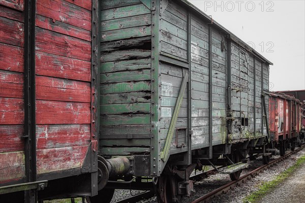 A weathered red and green goods wagon stands on tracks in the railway museum, Dahlhausen railway depot, Lost Place, Dahlhausen, Bochum, North Rhine-Westphalia, Germany, Europe