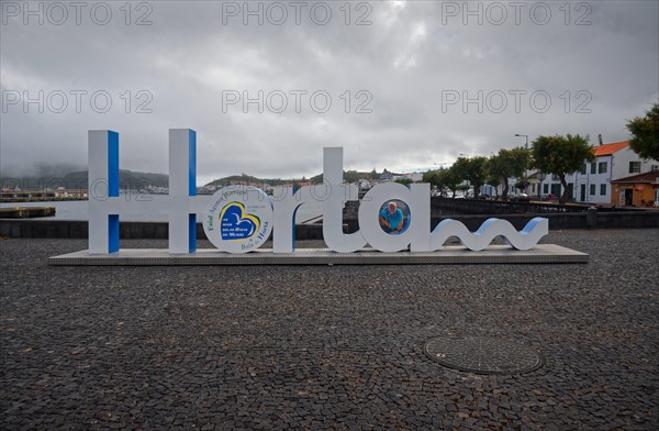 Lettering 'Horta' as a 3D sculpture in the public square of the harbour of Horta, Horta, Faial Island, Azores, Portugal, Europe