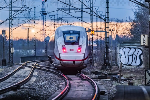 Railway line with many overhead lines and railway signals, InterCityExpress ICE of Deutsche Bahn AG, rear lights in the evening light, Stuttgart, Baden-Wuerttemberg, Germany, Europe