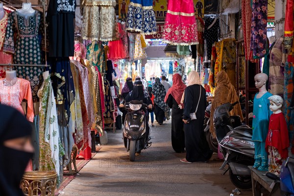 Veiled woman on scooter, bazaar at Charminar, Hyderabad, Andhra Pradesh, India, Asia