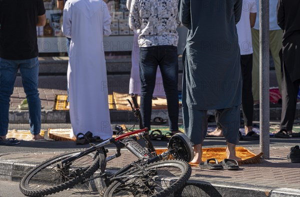 Midday prayer in front of a mosque, Al Fahidi neighbourhood, Dubai, United Arab Emirates, Asia