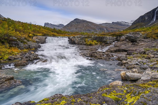 Autumn in Reinheimen National Park, mountains with river in Valldalen valley, Stigbotthornet mountain, More og Romsdal, Norway, Europe