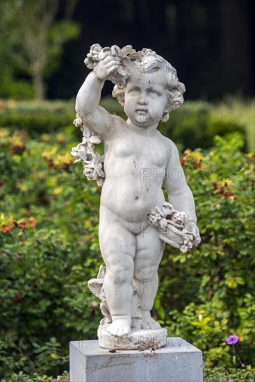 Angel statue in covered in bird droppings in park, garden of Ooidonk Castle, Kasteel van Ooidonk at Sint-Maria-Leerne, East Flanders, Belgium, Europe