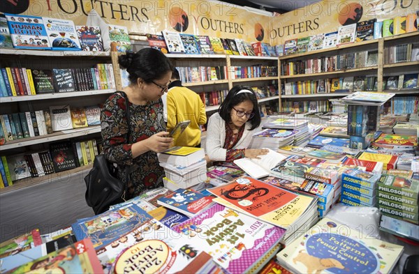 Book readers browsing books at a stall during Assam Book Fair, in Guwahati, Assam, India on 29 December 2023