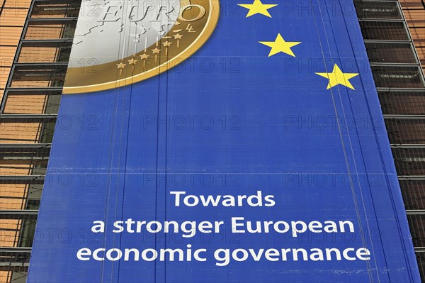 Banner about the euro hanging from the Berlaymont building of the European Commission, executive body of the European Union, Brussels, Belgium, Europe