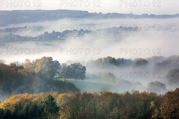 View over fileds and the village Sougne-Remouchamps in the mist, Aywaille, Liege, Belgian Ardennes, Belgium, Europe