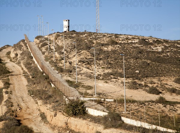 Security fence and look-out tower of military base in Melilla autonomous city state Spanish territory in north Africa, Spain, Europe