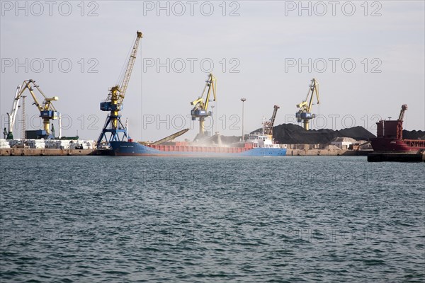 Cranes loading bulk carrier ship with rock ore at the port of Beni Ansar, Morocco, north Africa, Africa