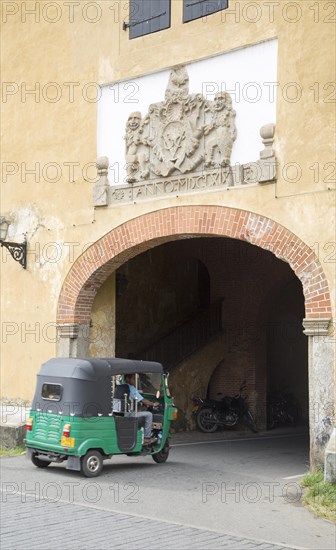 Motorised rickshaw at fort doorway exit in the historic town of Galle, Sri Lanka, Asia